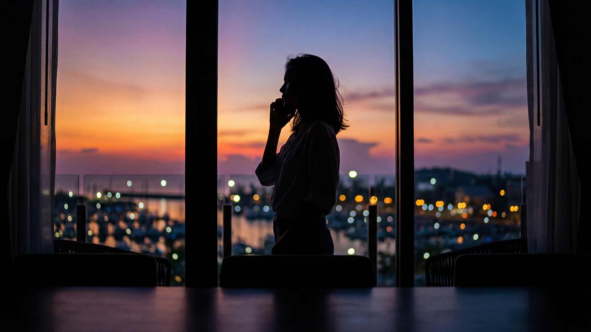 SEO strategist silhouette overlooking Phuket marina at dusk