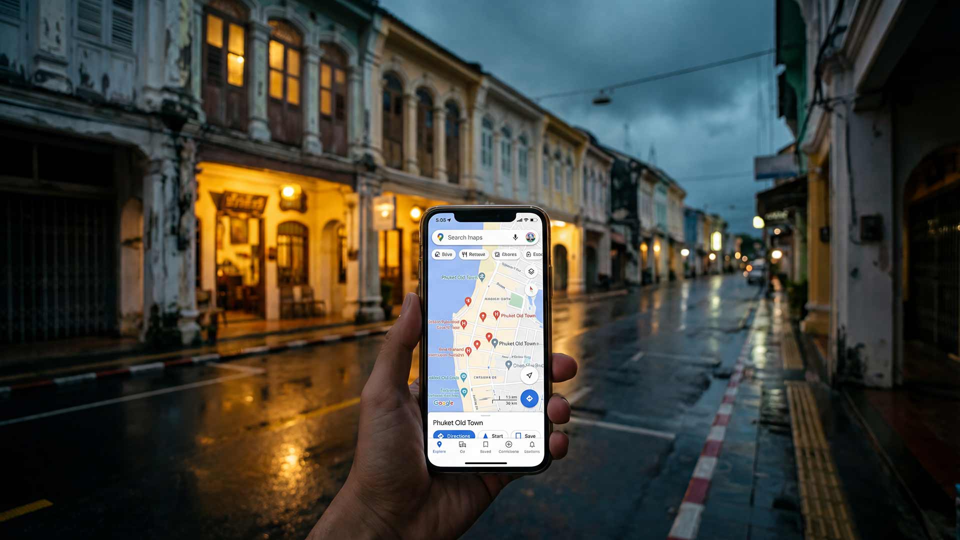 Phone showing Google Maps in Phuket Old Town at dusk