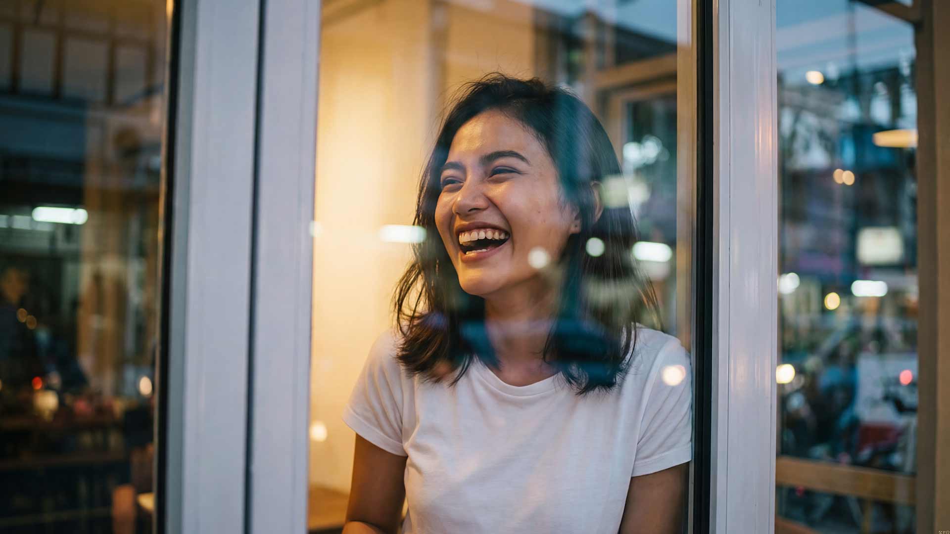 SEO strategist laughing with client through cafe window